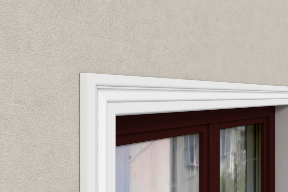 Moldura decorativa blanca instalada sobre marco de ventana, pared beige, acabado elegante