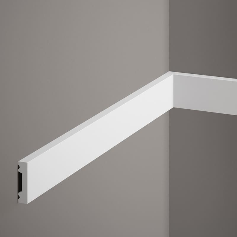 Moldura decorativa blanca para pared sobre fondo gris, diseño moderno y minimalista.
