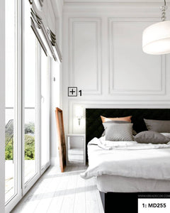 Dormitorio moderno con molduras decorativas en paredes blancas y suelo de madera clara