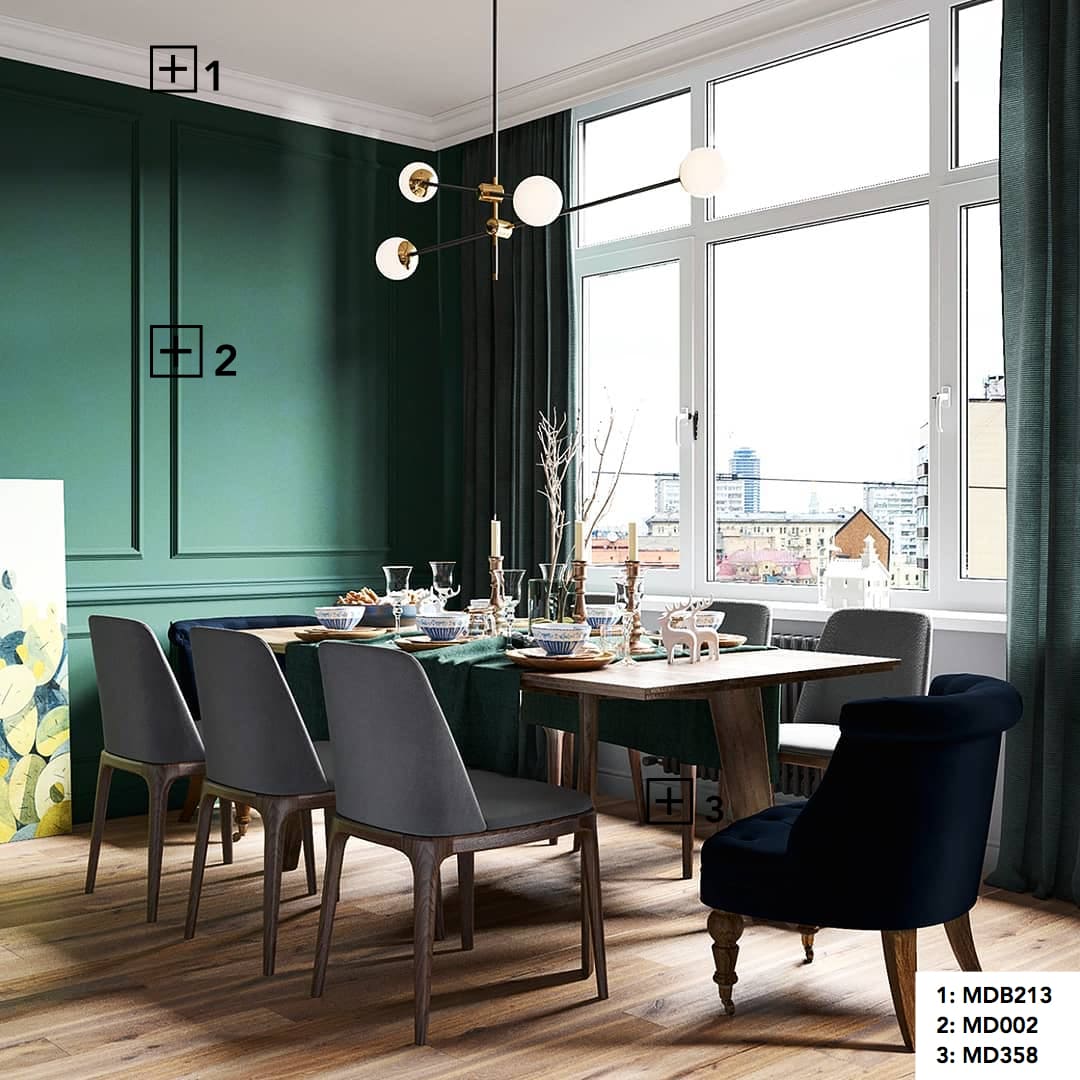 Comedor moderno con molduras decorativas en pared verde, rodapié blanco y suelo de madera.