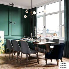 Comedor moderno con molduras decorativas en pared verde, rodapié blanco y suelo de madera.