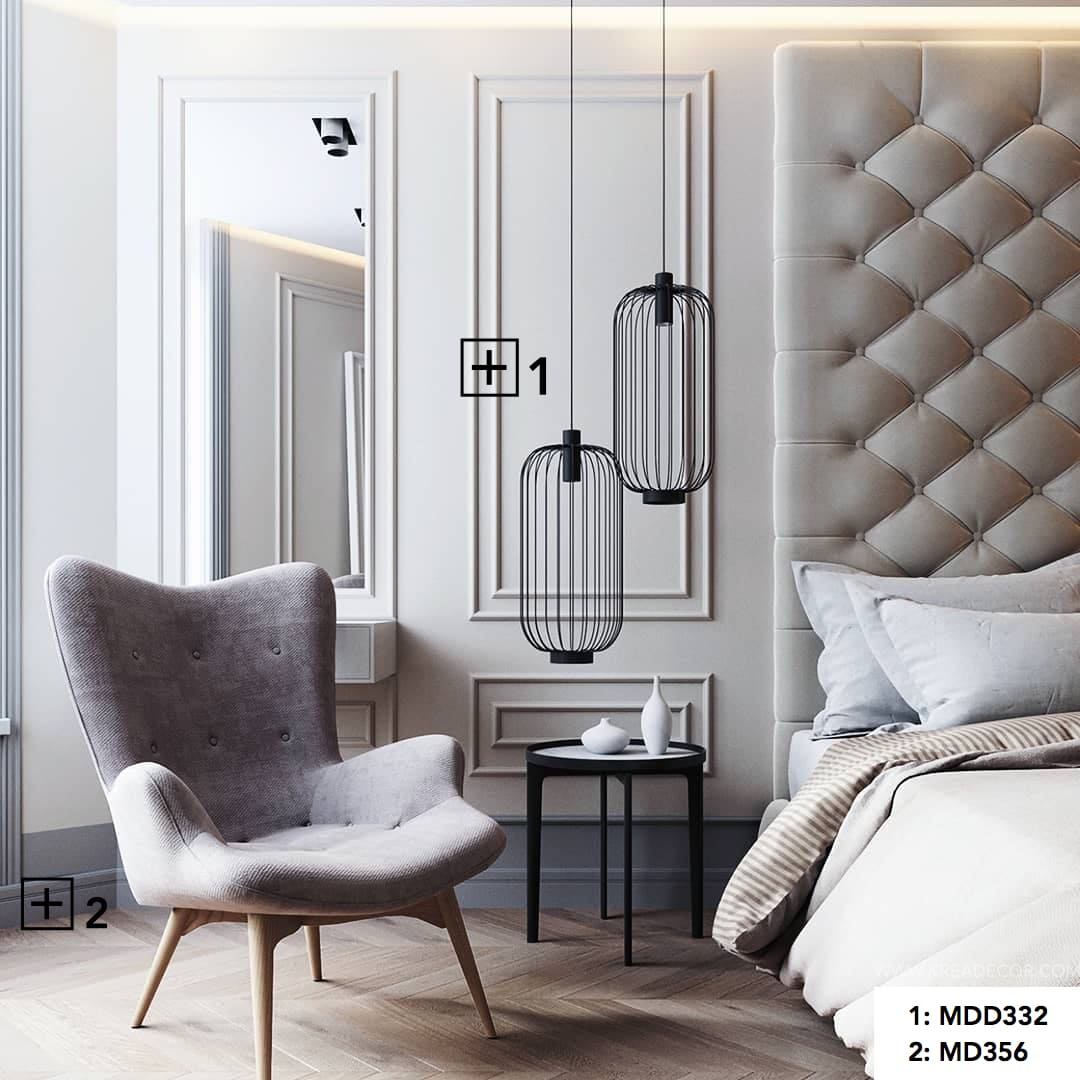 Dormitorio moderno con molduras decorativas en la pared y rodapié gris, sillón y lámparas colgantes.