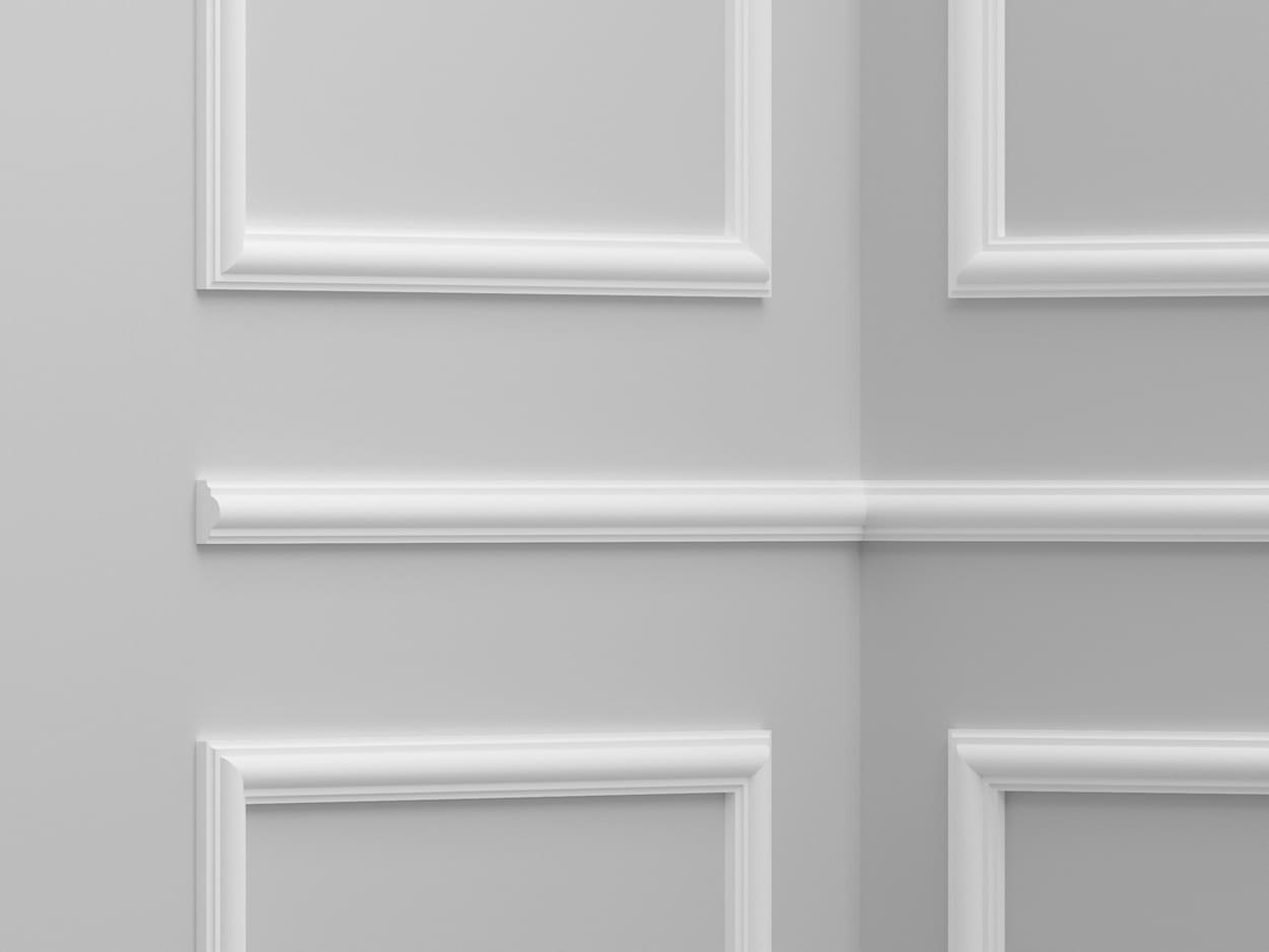 Molduras decorativas blancas en pared gris para interiores elegantes y modernos.