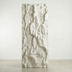 Textured decorative wall panel with a white, irregular stone-like finish for modern interiors.